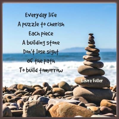 stones stacked on each other with poem build the puzzle of life by laura