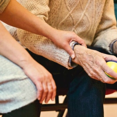 young girls hand on an older mans arm