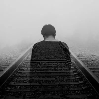 shadow of a man on railroad tracks