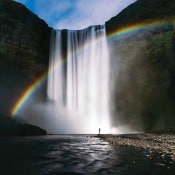 rainbow behind a water fall