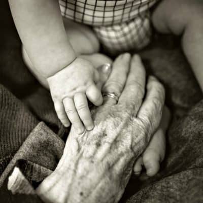 baby and old hands touching