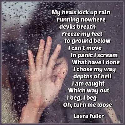 a girl with hand on a window pane in the rain with a poem written on it