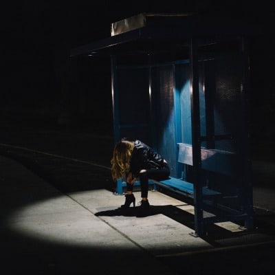 sad girl sitting on a bench