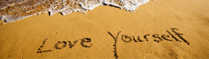 love yourself in sand